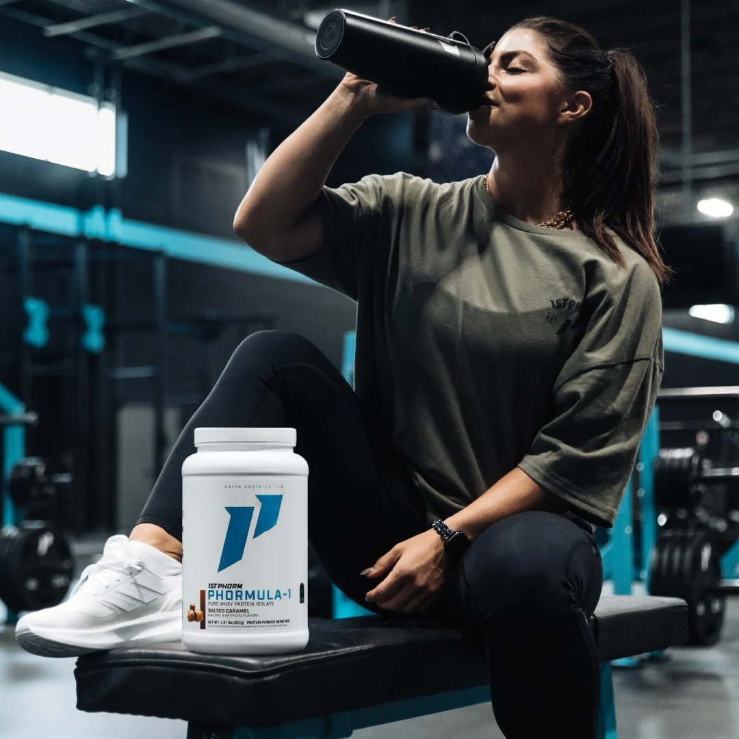 Woman in the gym with 1st Phorm Phormula-1 protein